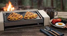hot dog roller grill making waffles outdoors on a wooden table cozy cooking scene