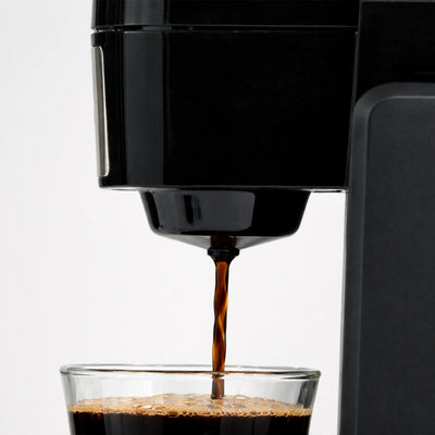 coffee maker dispensing fresh coffee stream close up detail