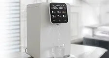 modern white countertop water dispenser on kitchen counter with glass