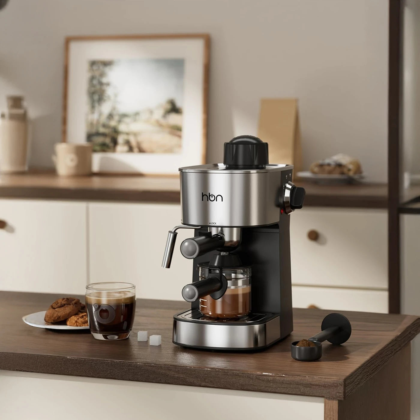 Espresso machine on a wooden counter with a glass of coffee and cookies in a cozy kitchen setting.