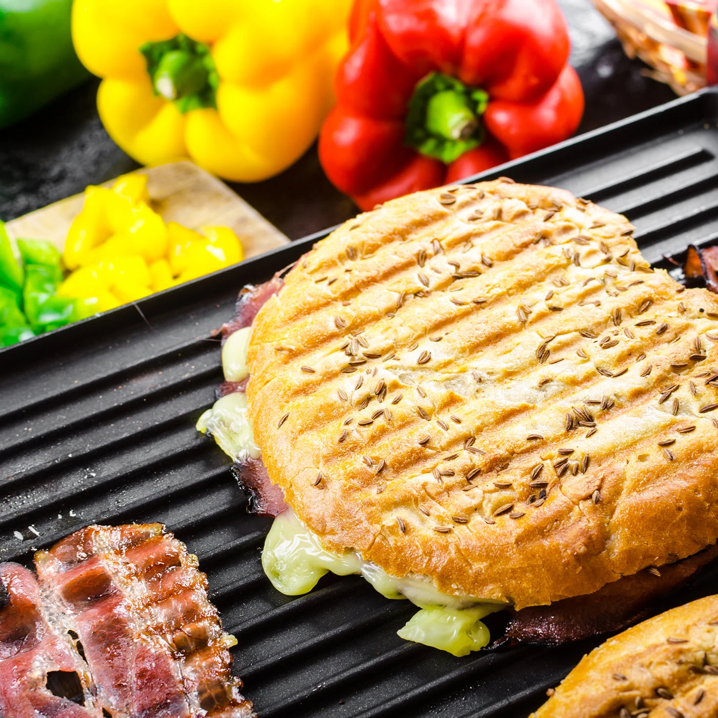 electric raclette grill cooking meat and vegetables indoor grill setup