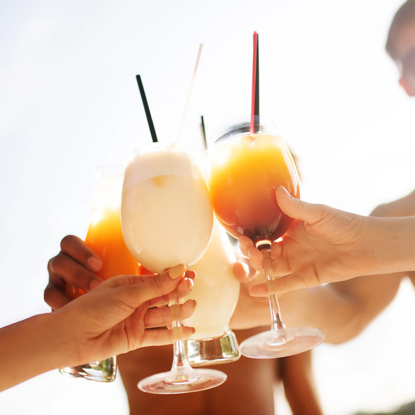 cheers with frozen drinks made by slushie machine cocktails and summer beverages