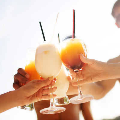cheers with frozen drinks made by slushie machine cocktails and summer beverages